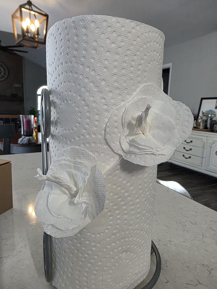 Paper towel roll decorated with handmade paper flowers