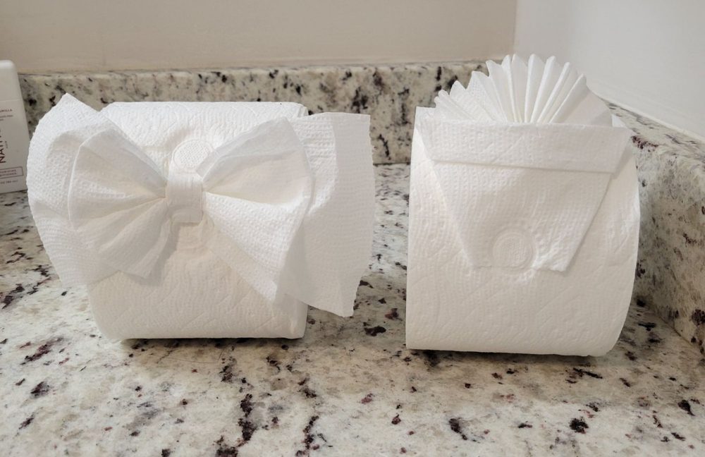 Toilet paper rolls folded into a decorative bow and fan